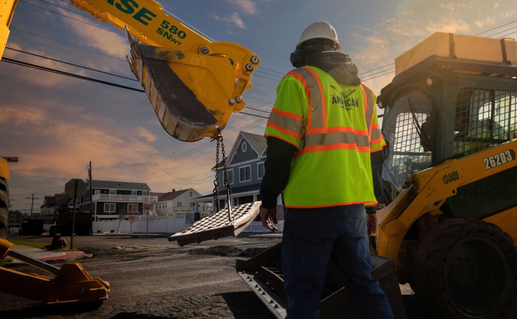 American asphalt crew working on stormwater inlet repair