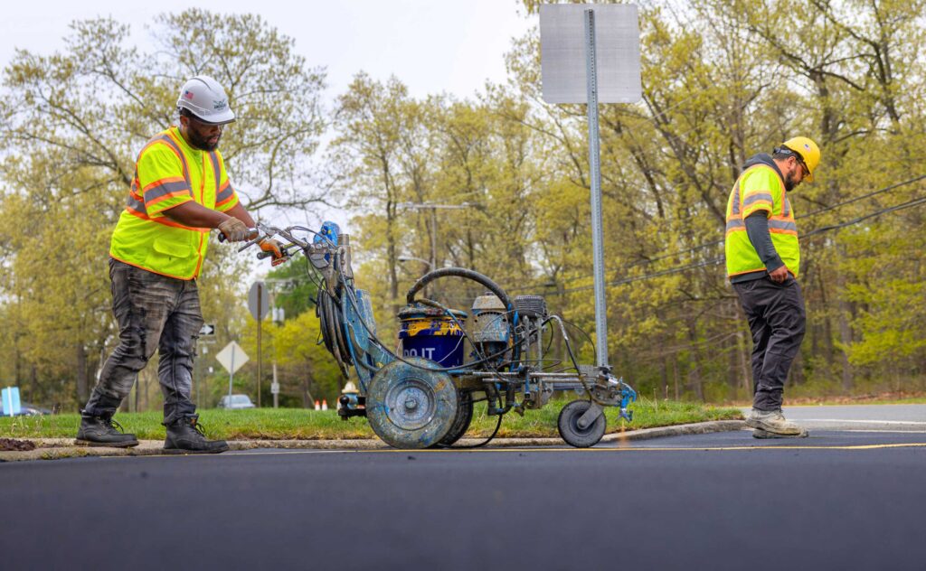 American Asphalt crew lays down precise stripes on parking lot