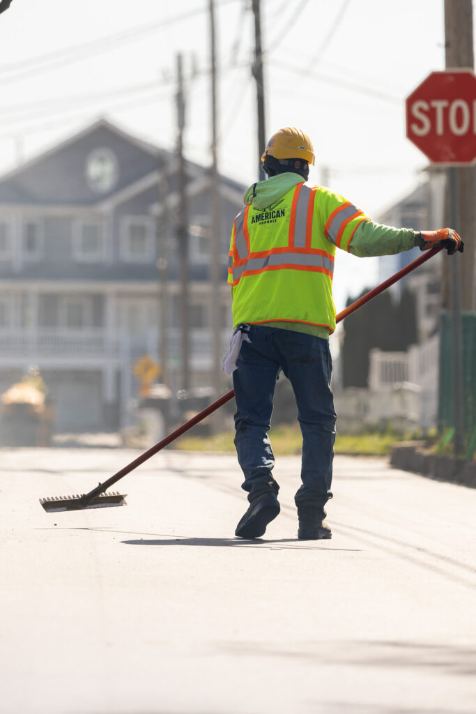 American Asphalt employee works on asphalt resurfacing job site