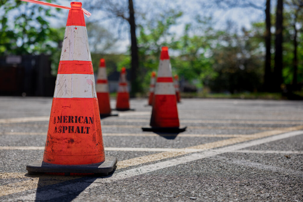 American Asphalt cones placed on parking surface for asphalt repair job