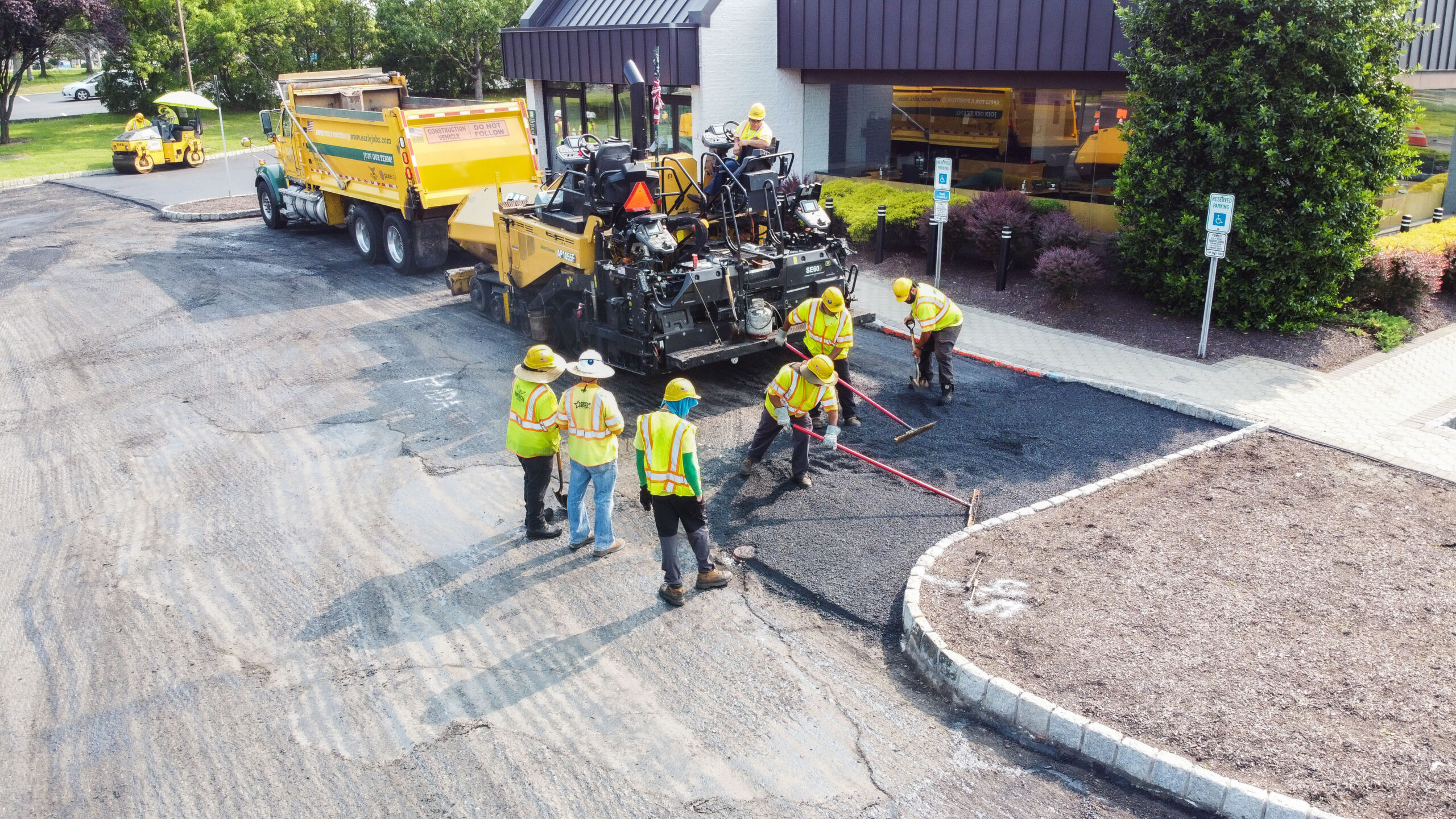 American Asphalt contractors installing new asphalt in handicap spots